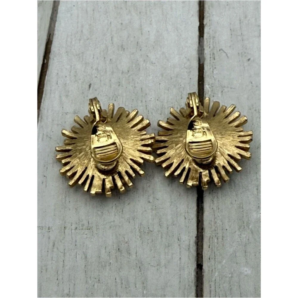 Vintage Monet gold tone starburst flower clip on earrings